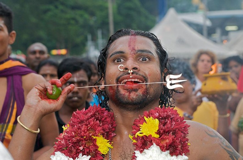Celebrant at Thaipusam with pierced cheeks